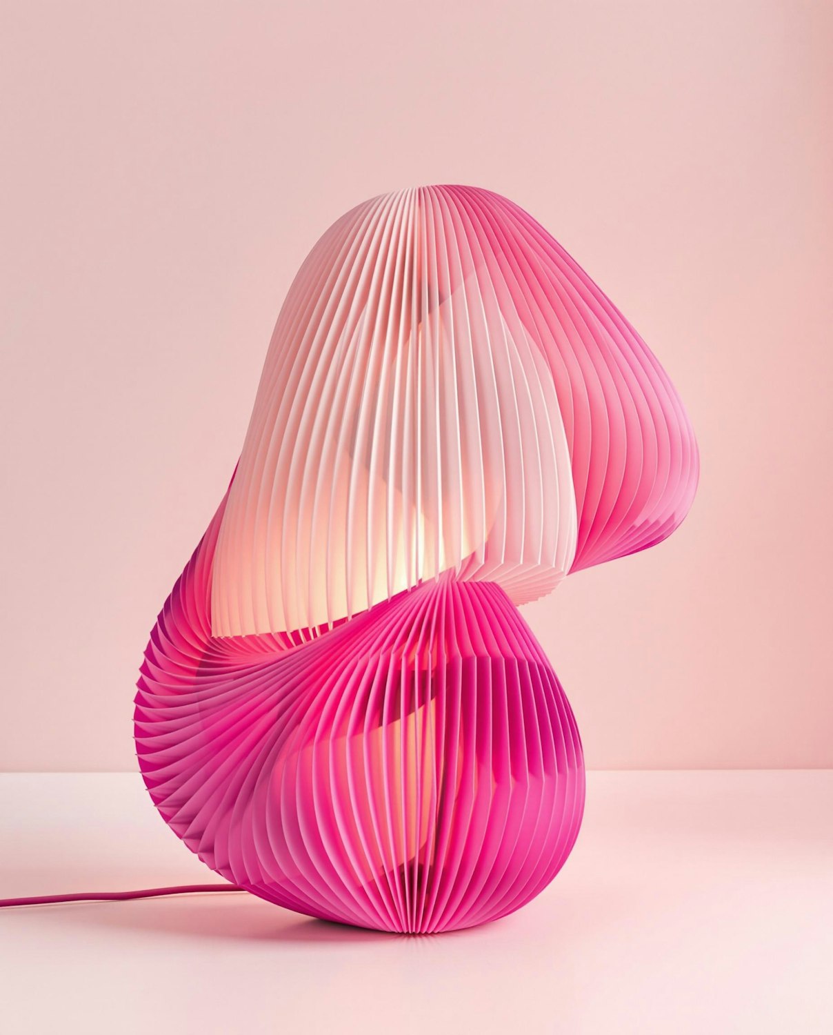 Pink pleated table lamp printed in translucent PLA, glowing softly